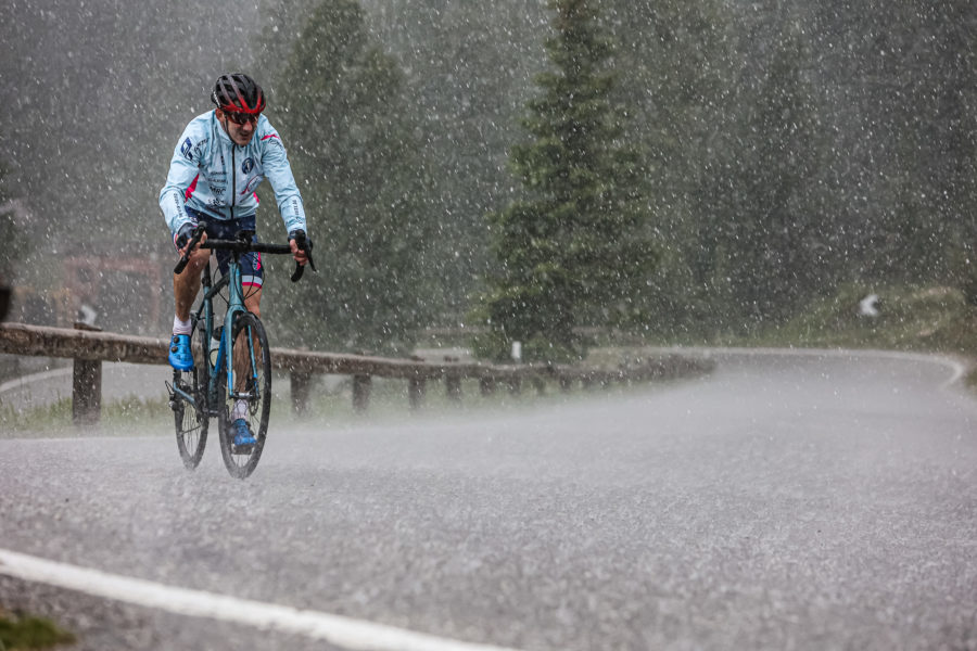 Extremsportler Guido Kunze fährt mit seinem Rennrad auf einem Pass der Sella Ronda durch heftigen Regen